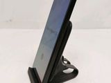 a cell phone that is sitting on a stand