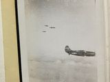 an old book with a picture of a plane flying in the sky