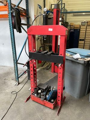 a red machine that is sitting in a garage