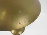 a gold lamp that is sitting on a table
