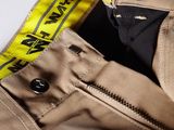 the back of a pair of khaki pants with a yellow label on the side