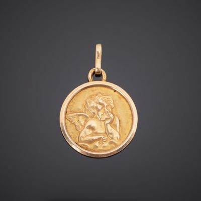 a gold coin with an image of a woman holding a baby