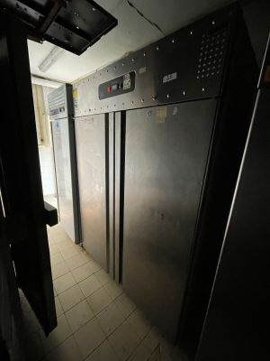 an image of a refrigerator in a dark room with a door open