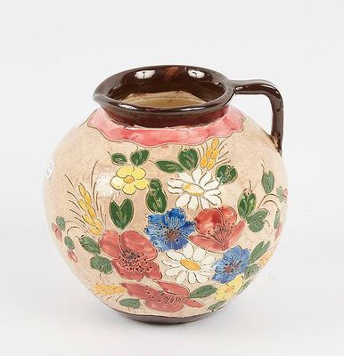 a vase with flowers painted on it on a white surface