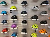 many helmets on display on the wall in the store