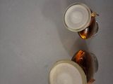two beer glasses that are sitting on a table