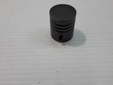 a small black object sitting on top of a white surface