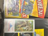 a lot of comic books that are on the table