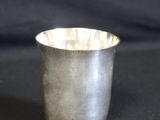 une vieille coupe en argent posée sur une table noire