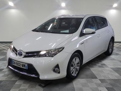 the toyota corollant is parked in a large room with checkered flooring