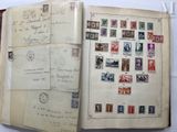 an open book with a lot of stamps on it sitting on top of a table