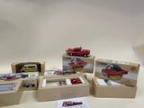 five boxes of toy cars on a white surface