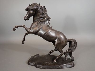 statue en bronze représentant un cheval dressé sur ses pattes arrière, posée sur un socle