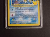 a pokemon card in a plastic container on a table