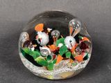 a glass ball with a bunch of small animals inside of it