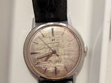 an image of a close up of a wrist watch on a white surface