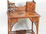 a wooden desk with a carved top on a white background