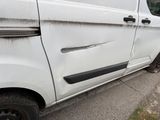 a white van that is parked on the side of the road