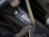 a close up of a car ' s engine with a stick sticking out of it