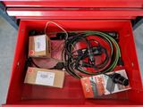 a red tool box with many wires and wires in it