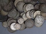 a pile of silver coins sitting on a table