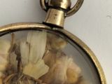 an image of a close up of a pocket watch with a bunch of food inside of it