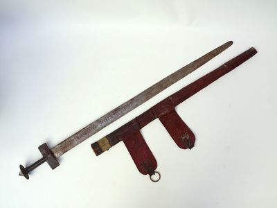 an old sword and a wooden handle on a white surface