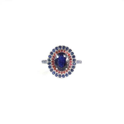 an image of a ring with a blue stone surrounded by blue and red stones
