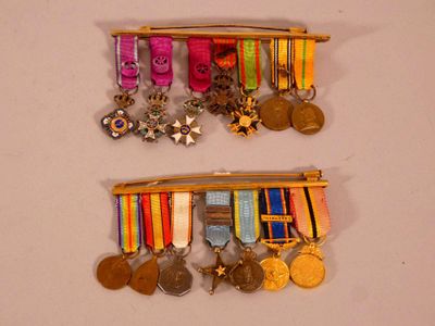 two medals hanging on the wall next to each other