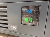 a clock on the side of a machine that is on the floor