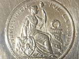 an old silver coin with a woman sitting on a horse