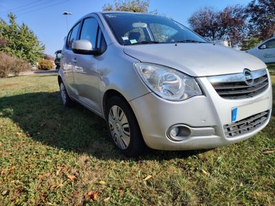 a picture of a silver car parked in the grass