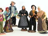 five figurines of people dressed in traditional clothing