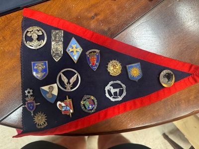 a flag with a lot of badges on it sitting on a table