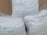 three bags of toilet paper sitting on top of a cardboard box