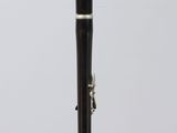 a black and silver instrument on a clear stand