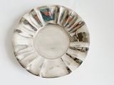 a silver plate with a flower design on it