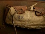 an old bag with a number on it sitting on a chair