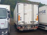 two trucks parked next to each other in a parking lot