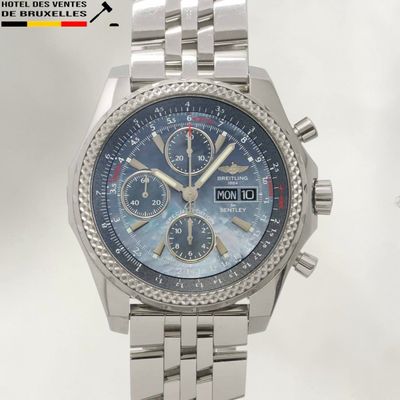 a silver watch with a blue dial on a bracelet