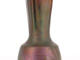 a purple vase that is sitting on a white surface