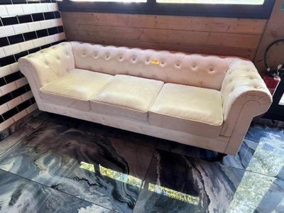 a white couch sitting in a room with black and white tiles