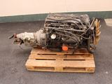 a small engine on a pallet in a parking lot