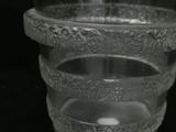 a clear glass vase with a decorative design on it