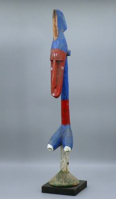 a close up of a sculpture of a bird on a wooden base