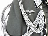 a close up of a uniform with a rope and a cell phone