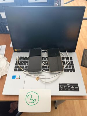 a laptop computer sitting on top of a wooden desk