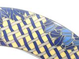 a close up of a blue, yellow and white surfboard on a white surface