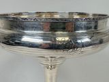 a silver plate with a rose design on it