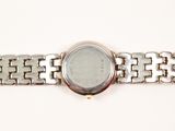 an image of a close up of a wrist watch on a white surface
